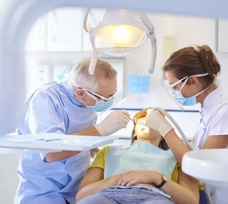 Dentists treating patient in chair