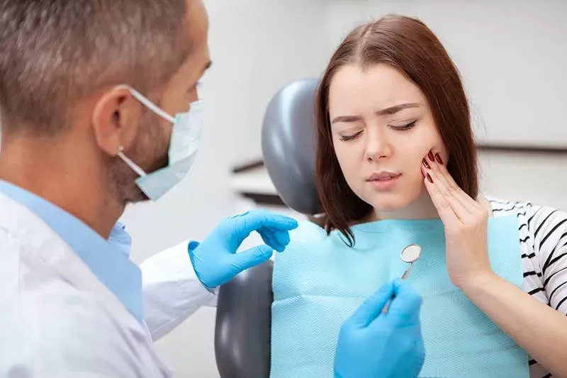 Dentist examining patient tooth pain